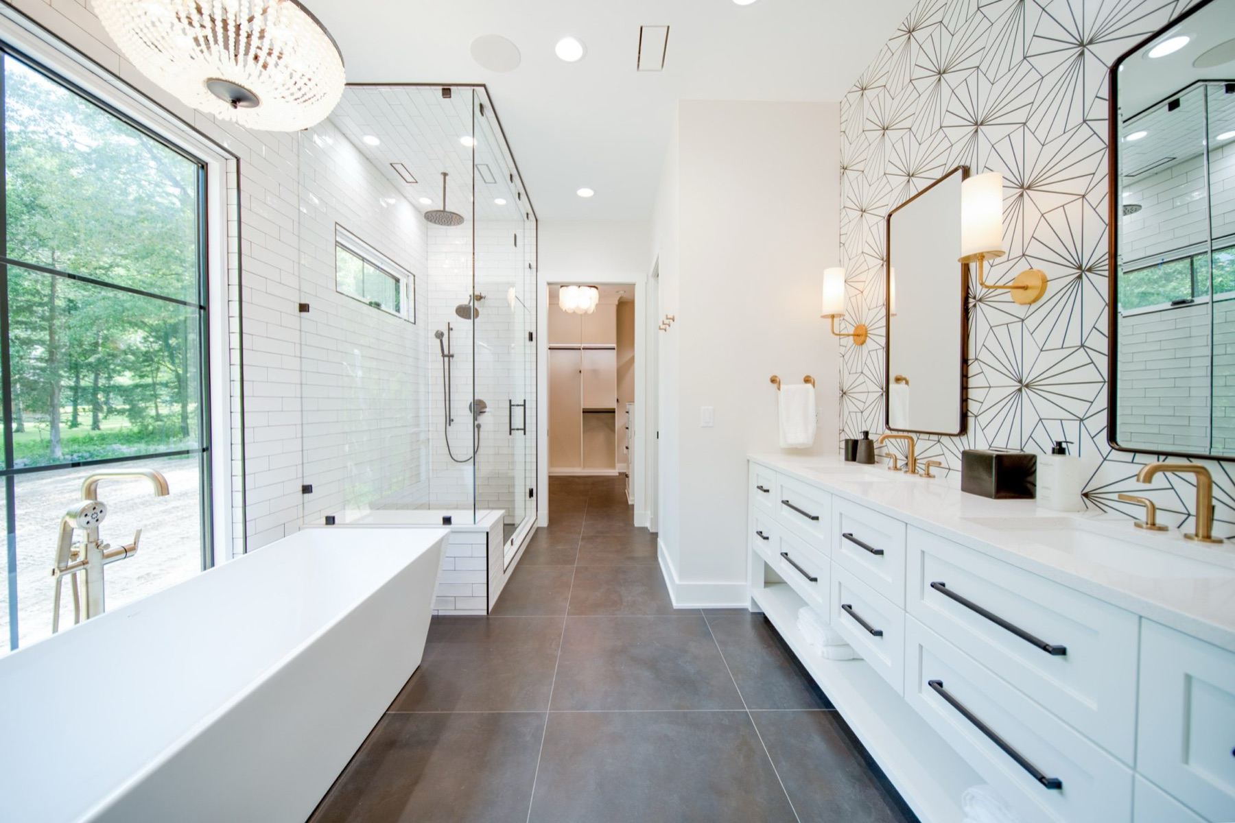 Bright custom bathroom with freestanding tub and glass shower