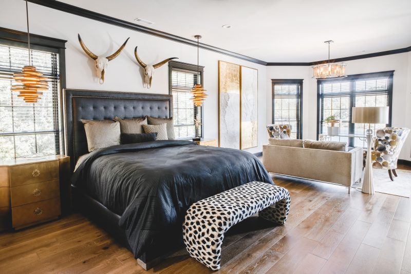 Primary bedroom suite with custom trim and designer lighting