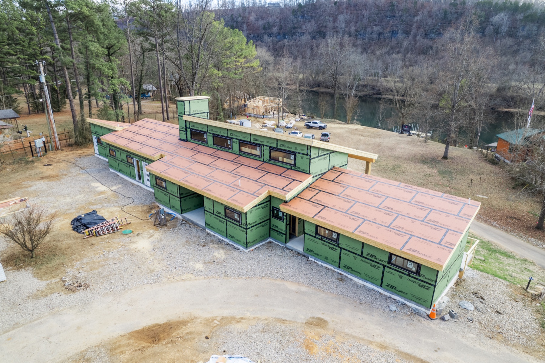 Aerial view of a custom home under construction on the riverfront
