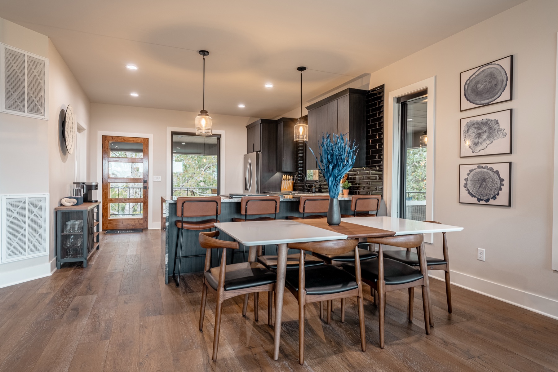 Custom dining area with dark cabinetry and wood dining chairs