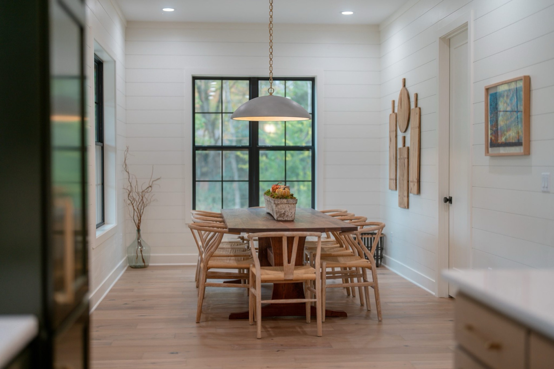 Bright breakfast nook with pendant lighting and custom millwork