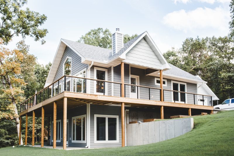 Hillside custom home with full-width wooden deck