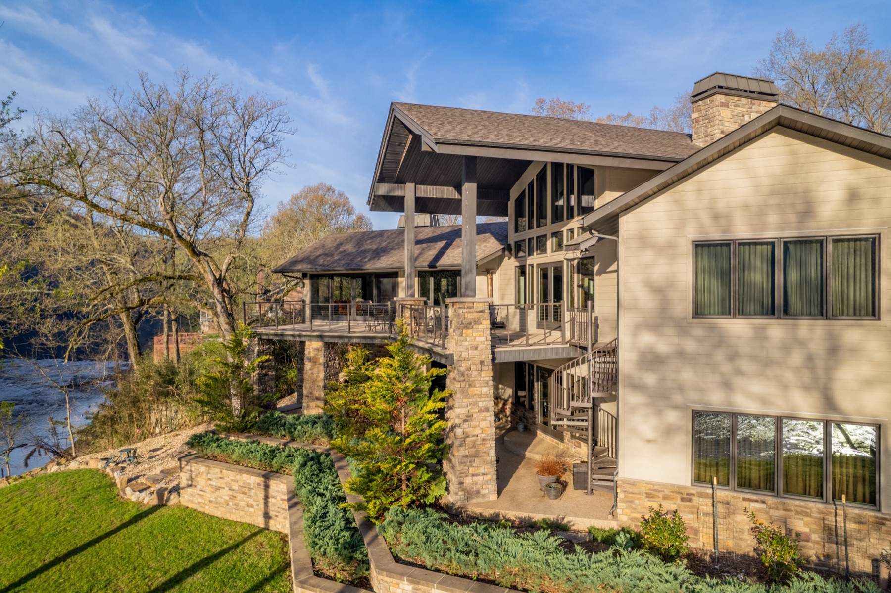 Stone and timber custom lodge home overlooking the river