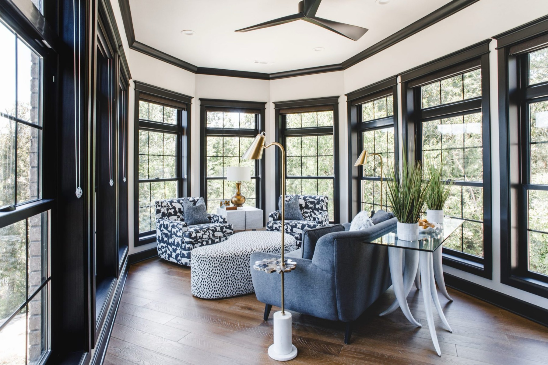 Custom sunroom with bay windows and designer furnishings